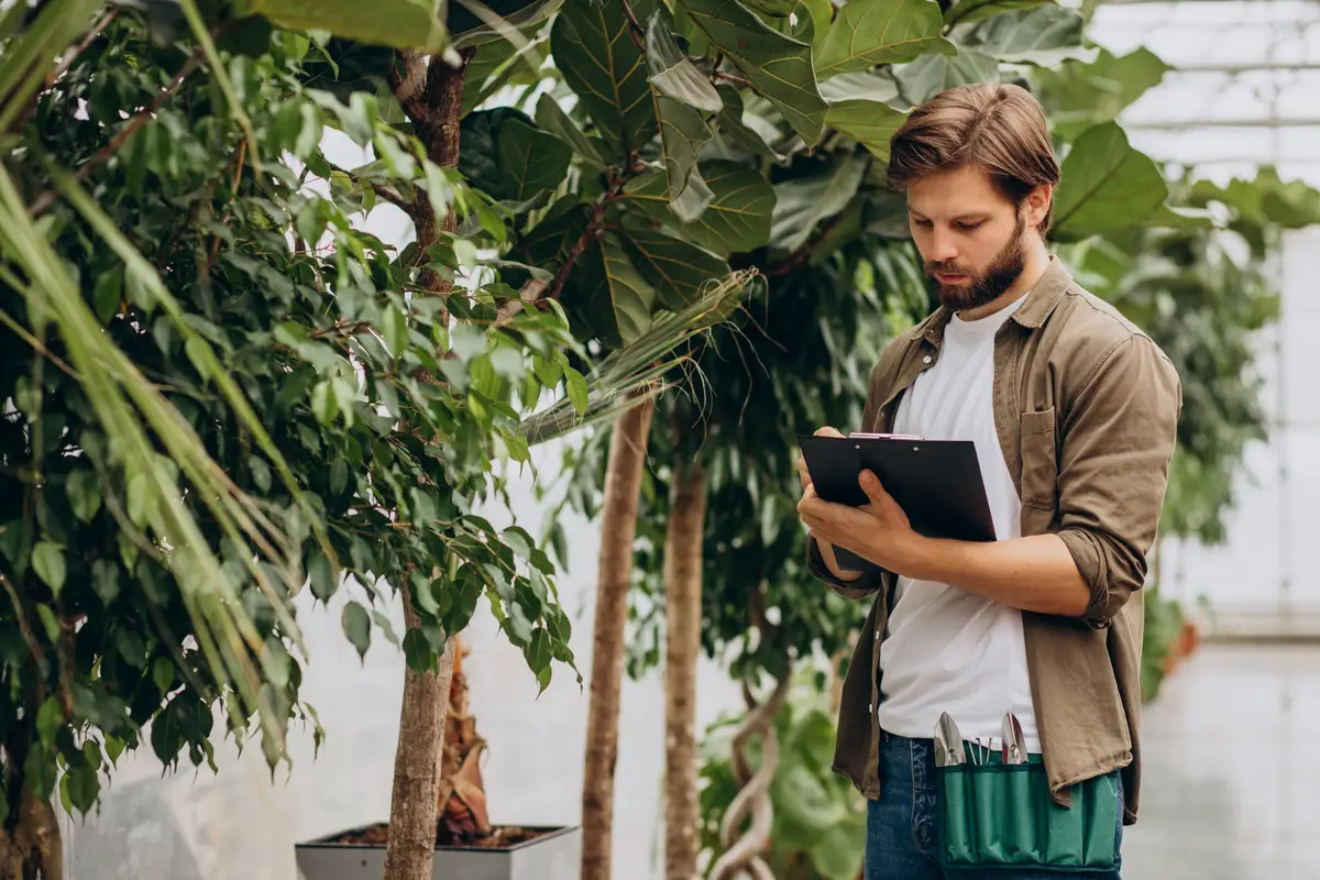 Man florist working in green house