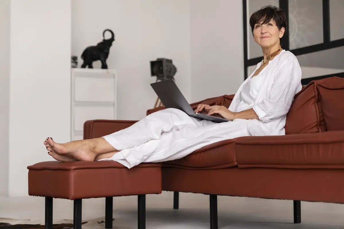 Full shot rich woman sitting at home