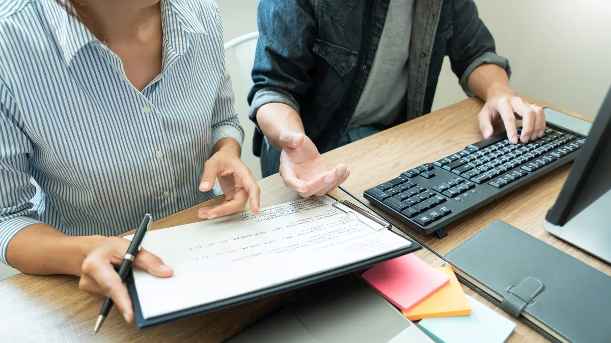 Midsection of colleagues discussing in office
