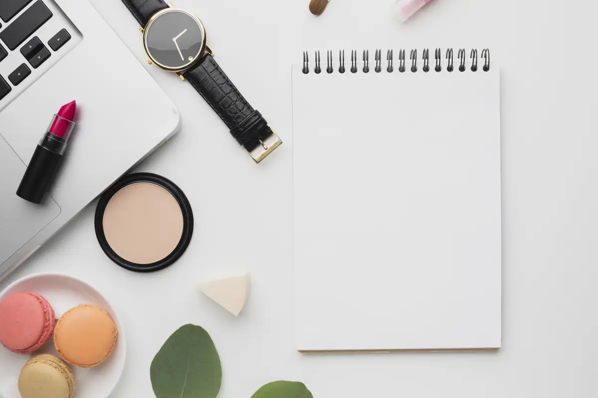 Flat lay arrangement with laptop and notebook