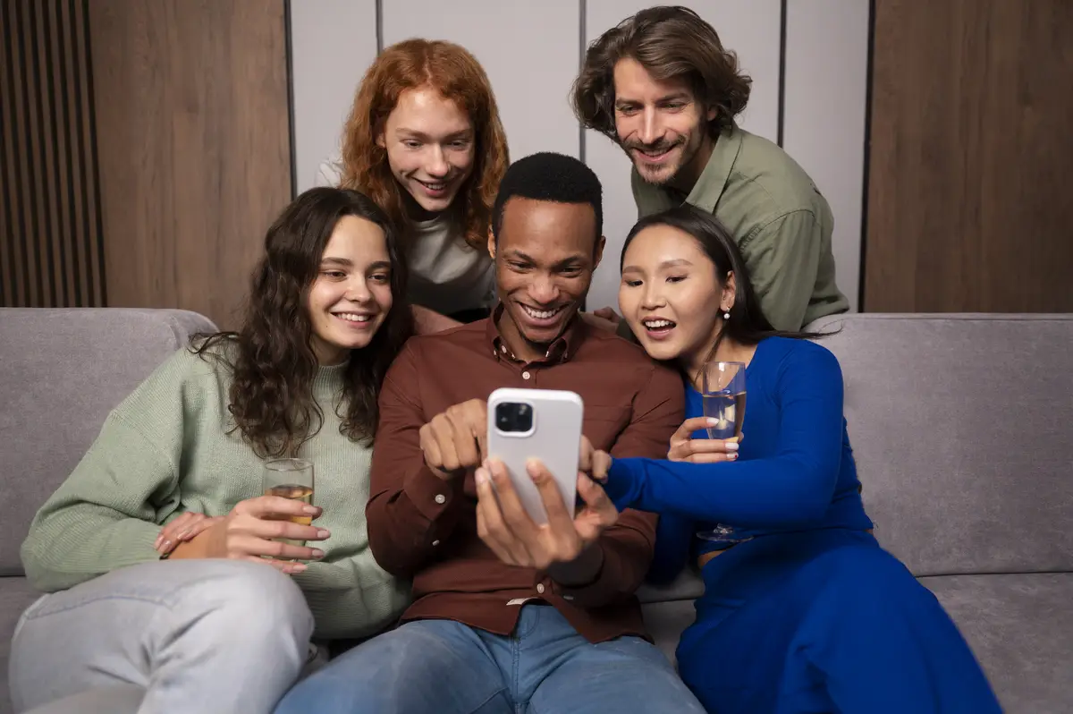Friends reading cell phone messages front view
