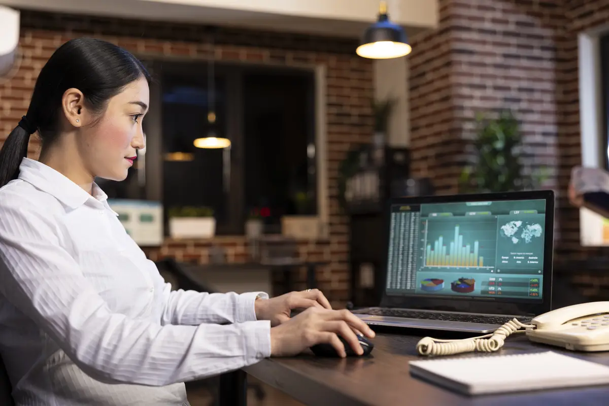 Manager checking company data on laptop