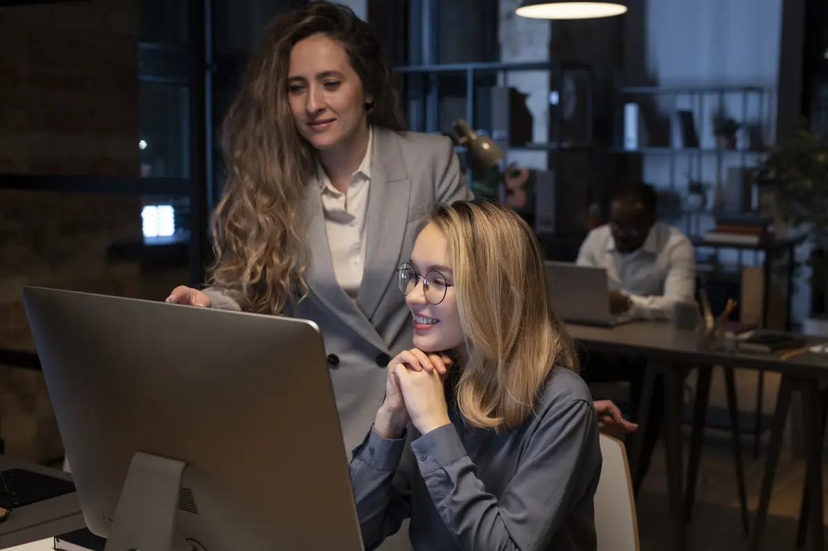 Coworkers looking the monitor