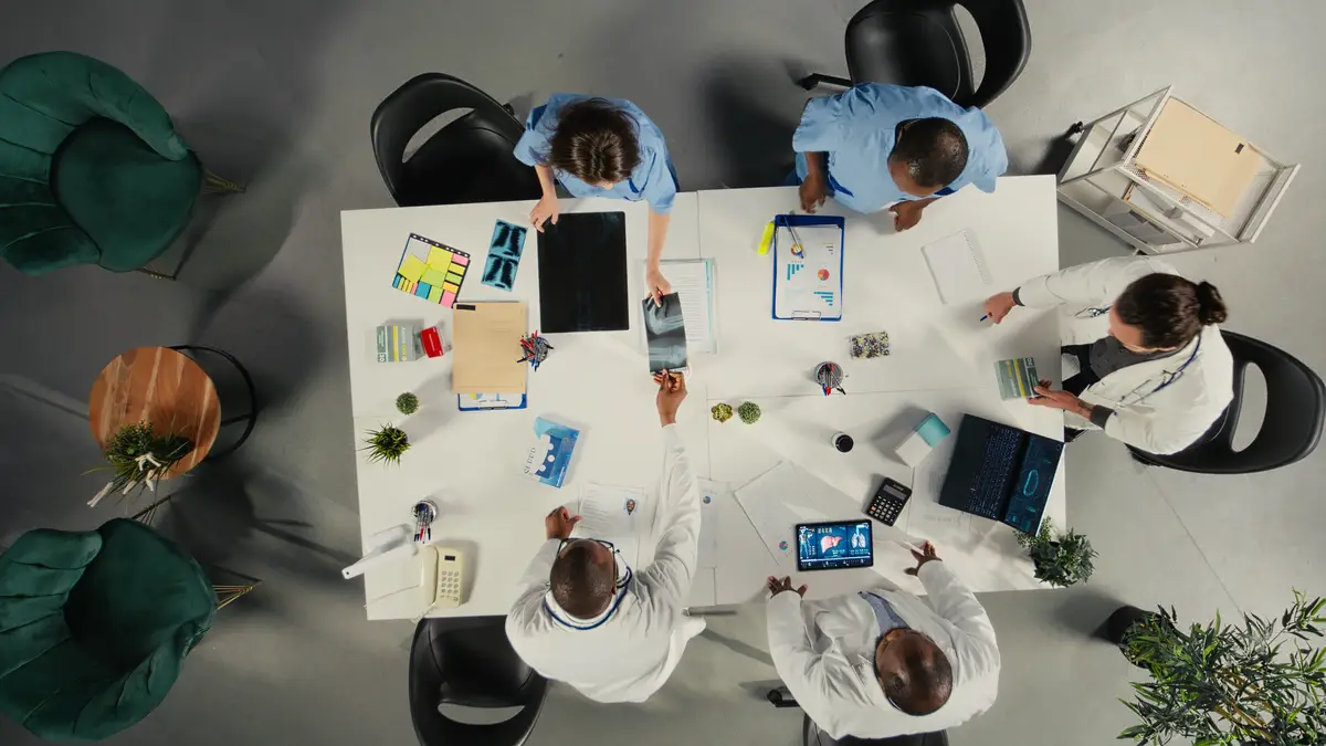Top down view of medical staff participating in a clinical discussion on diagnosis and treatment