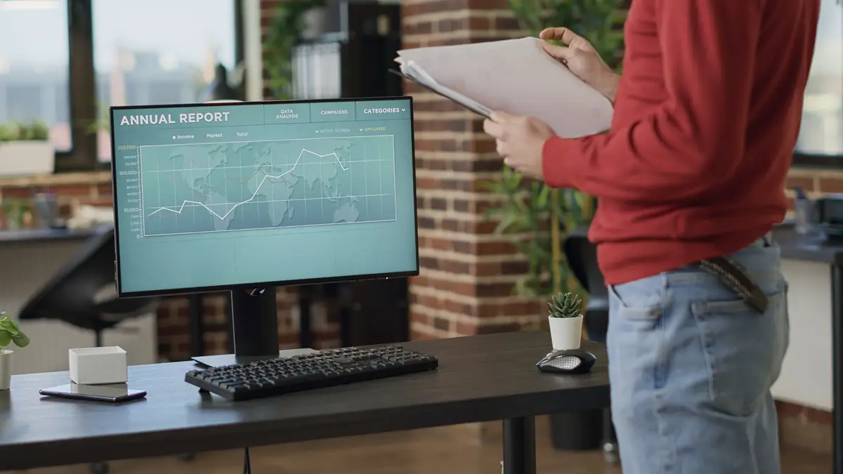 Financial broker analyzing stock trade market on computer, using exchange hedge fund statistics to create investment profit. Entrepreneur working with forex and real time sales trend. Handheld shot.