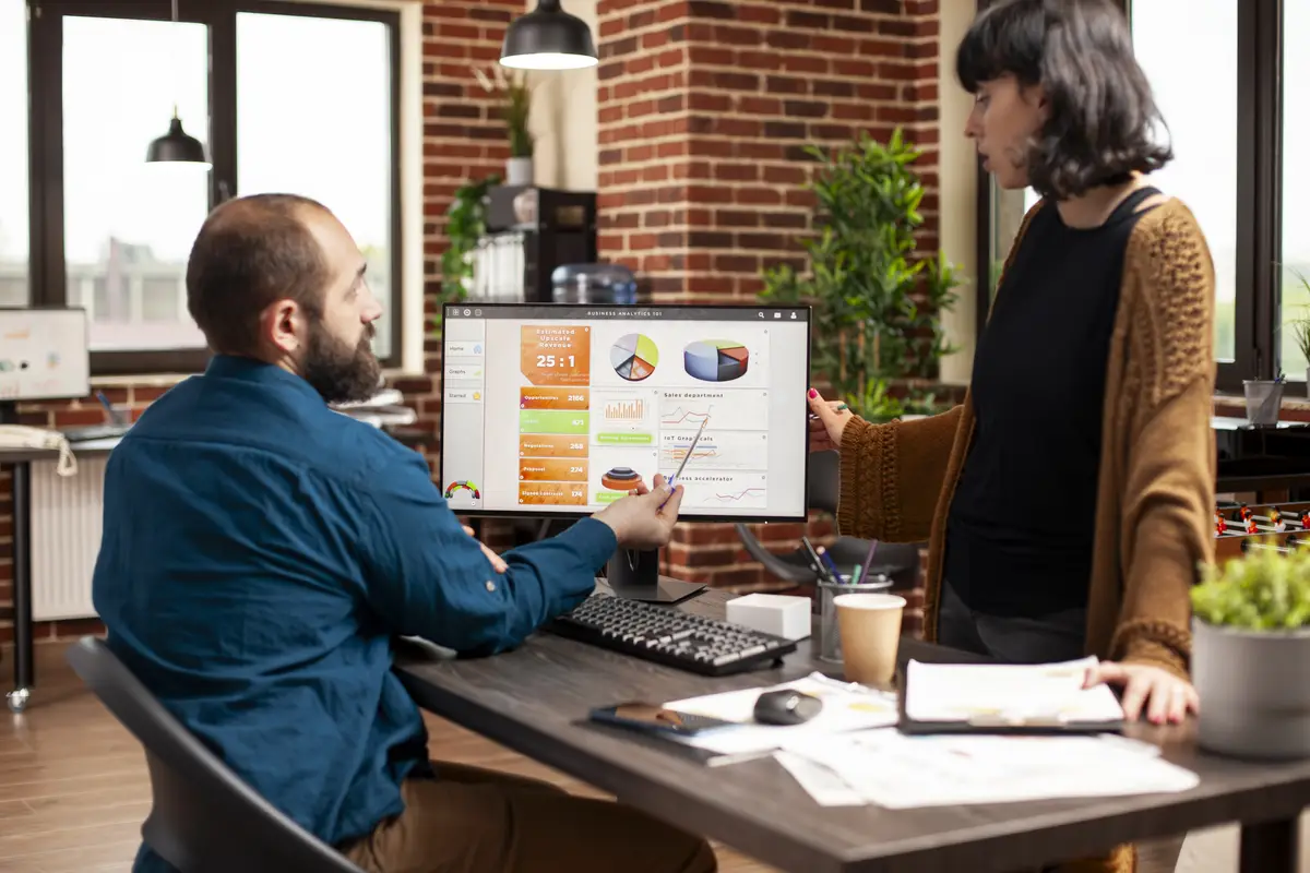 Woman listening to businessman in office
