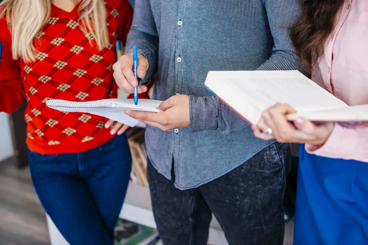 Crop students studying in library