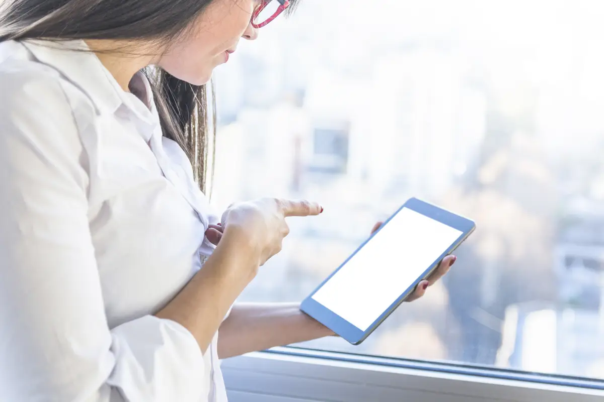 Businesswoman pointing finger on digital tablet screen