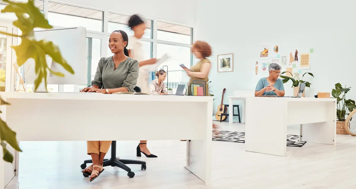 Happy coworking speed and a busy office of women for business corporate career and staff Smile diversity and a fast group of employees in the workplace with motion at a company in the workforce