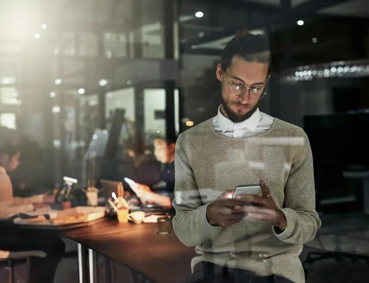 Phone office and business man at night for research online conversation and social media Corporate workplace communication and male with smartphone for writing email networking and text message