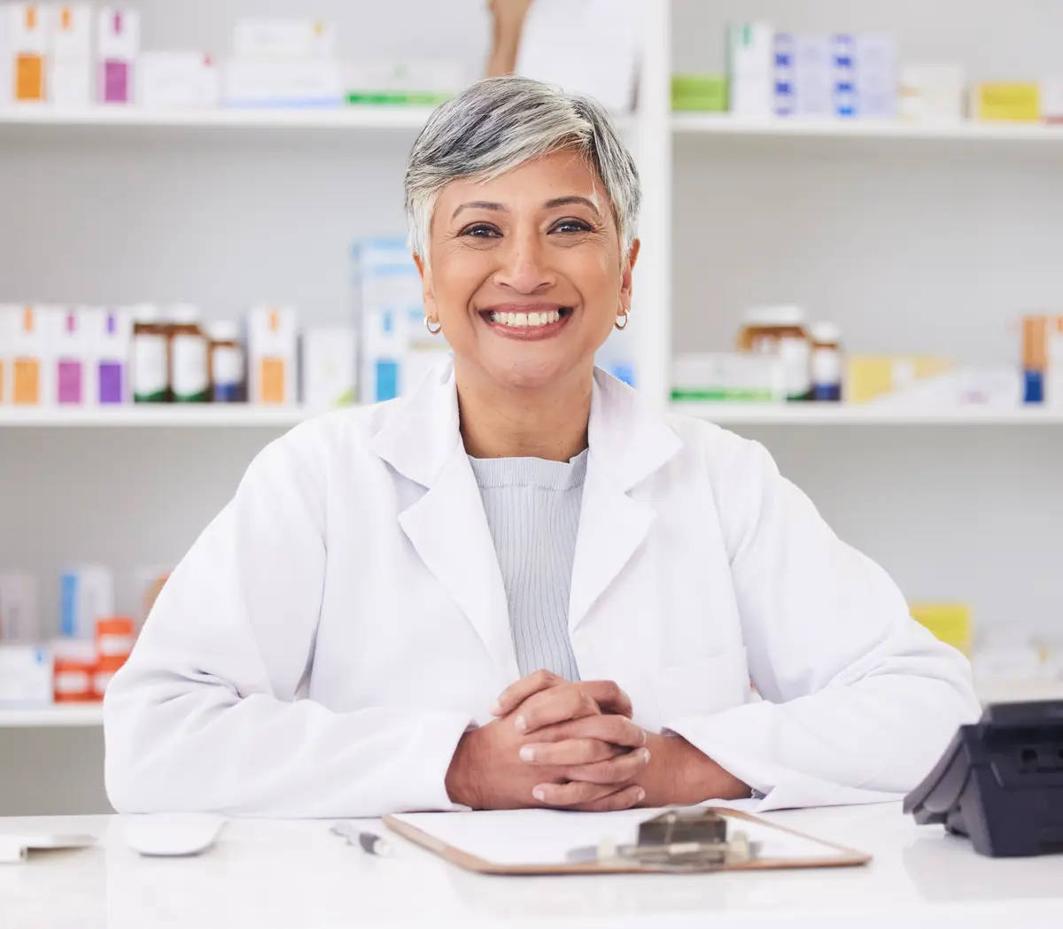 Pharmacy happy and portrait of consulting woman for medicine service or emergency healthcare Smile doctor and a mature female pharmacist in a career as a pills distribution consultant at a clinic