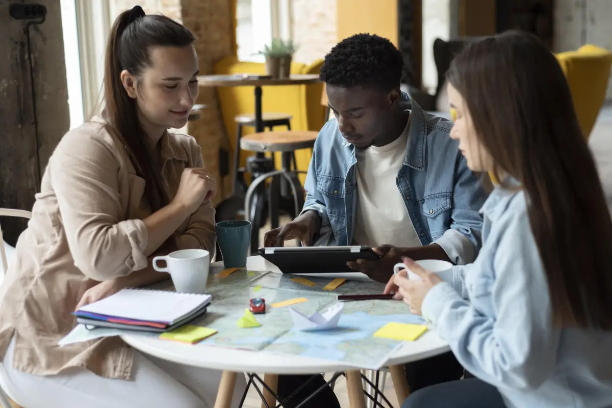 Group of friends planning a trip in a cafe