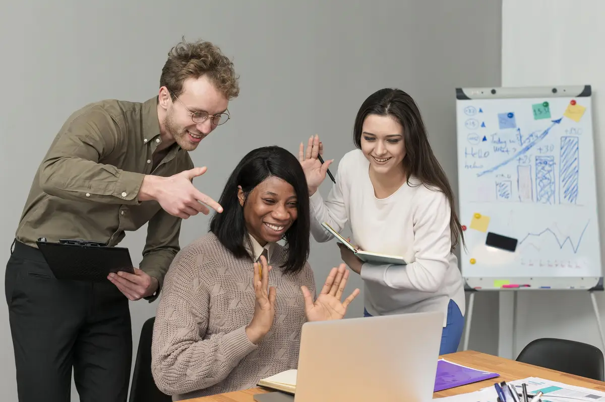Group of people teaming up at work