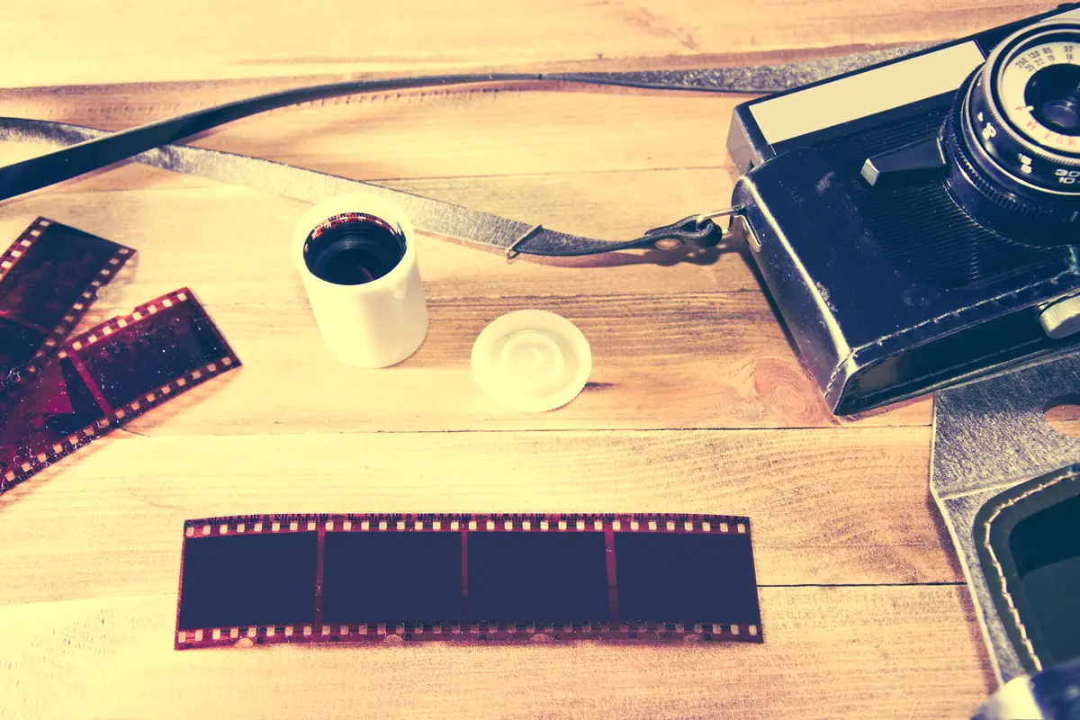 Retro vintage camera on wooden background.