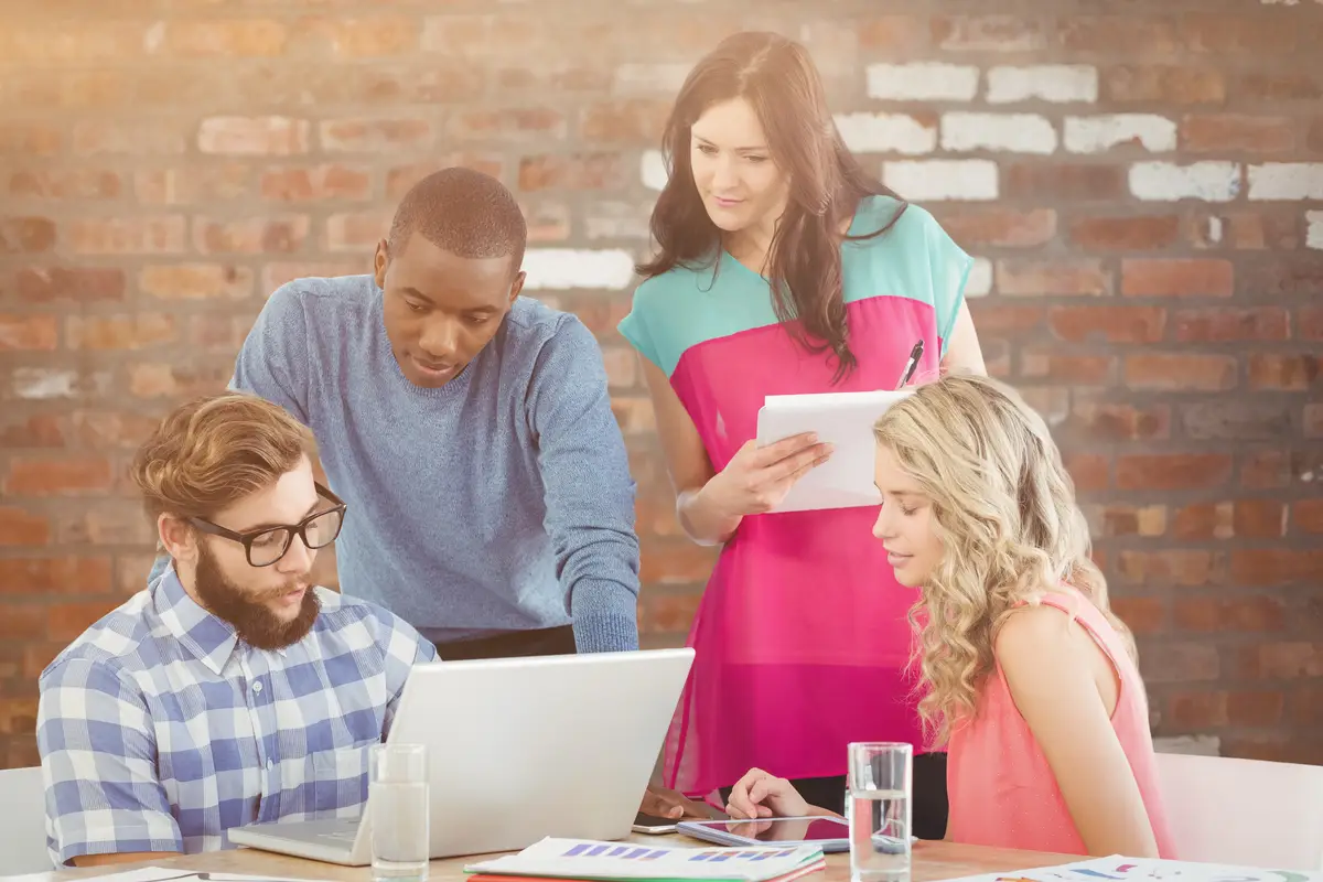 Composite image of man discussing with coworkers at desk