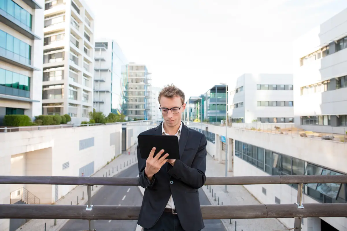 Focused serious professional working on tablet