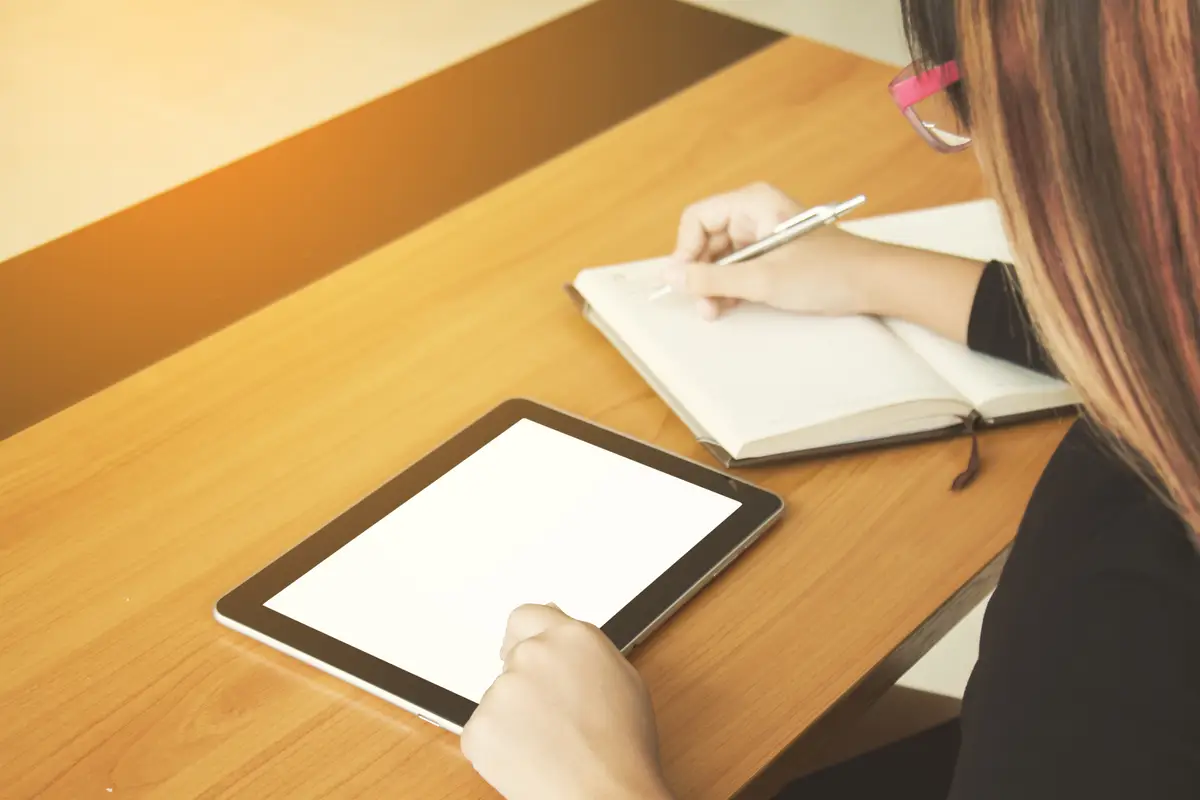 Teenage freelance working business on tablet.