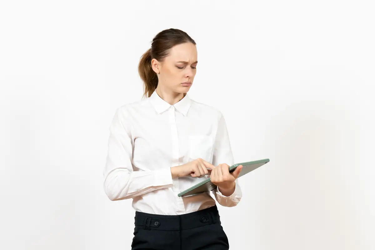 Front view young woman in white blouse holding huge calculator on white desk office female emotion feeling job