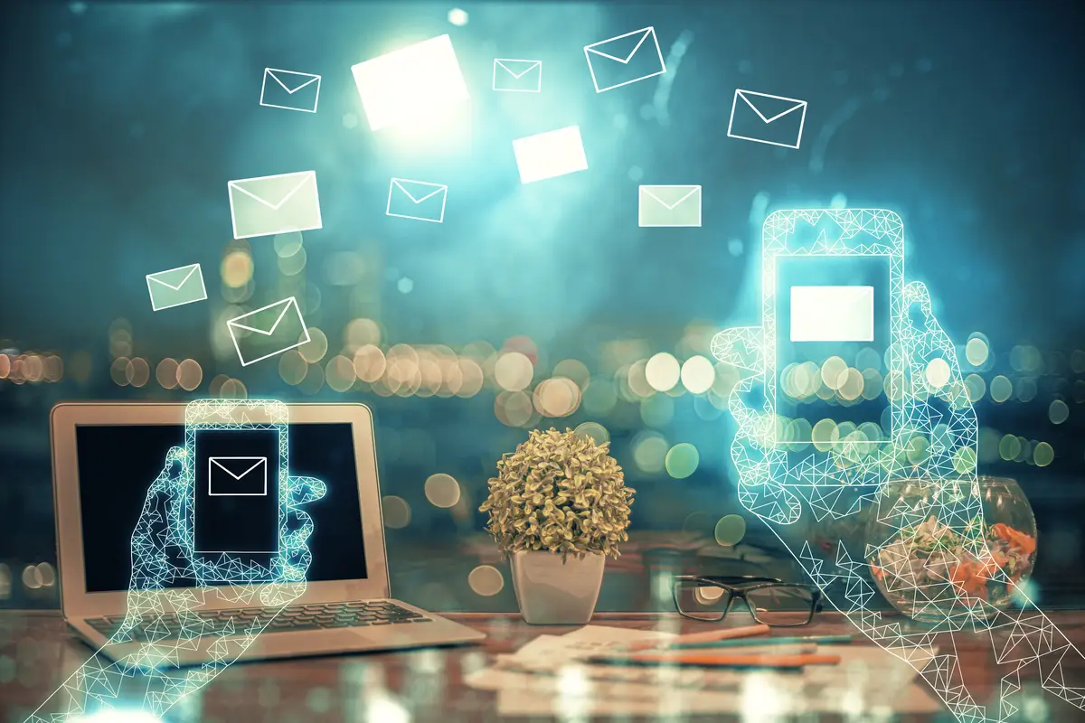 Desktop computer background in office and flying envelops hologram drawing Multi exposure Electronic mail concept