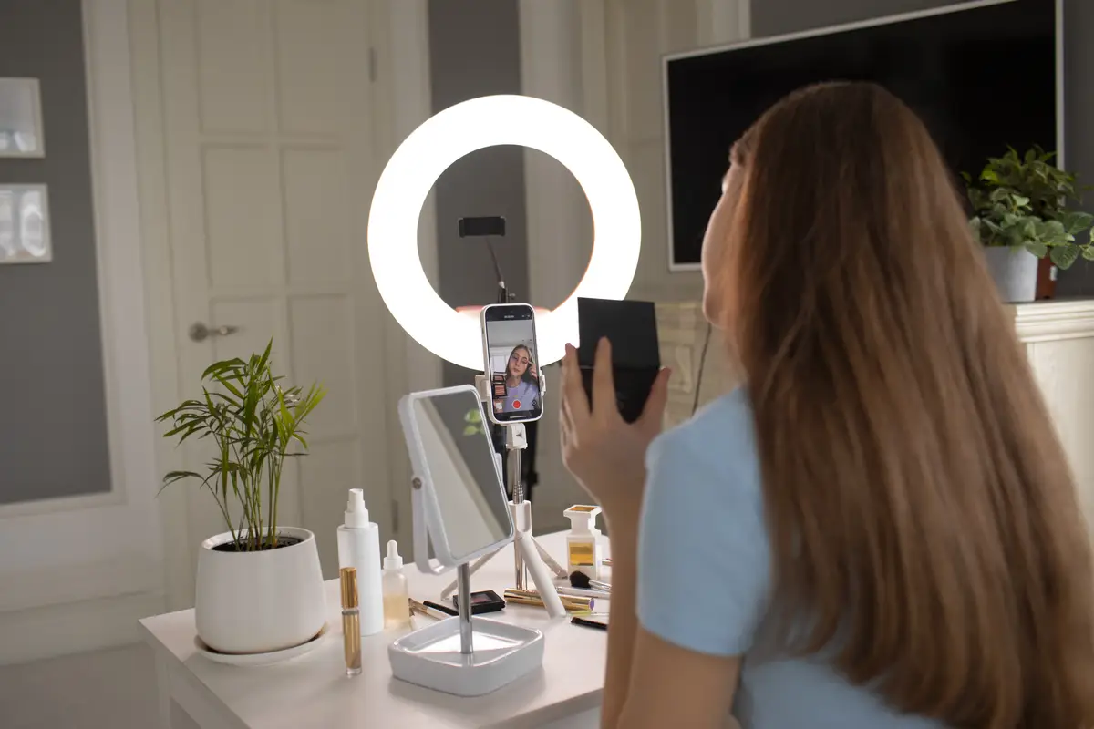Side view girl putting on makeup