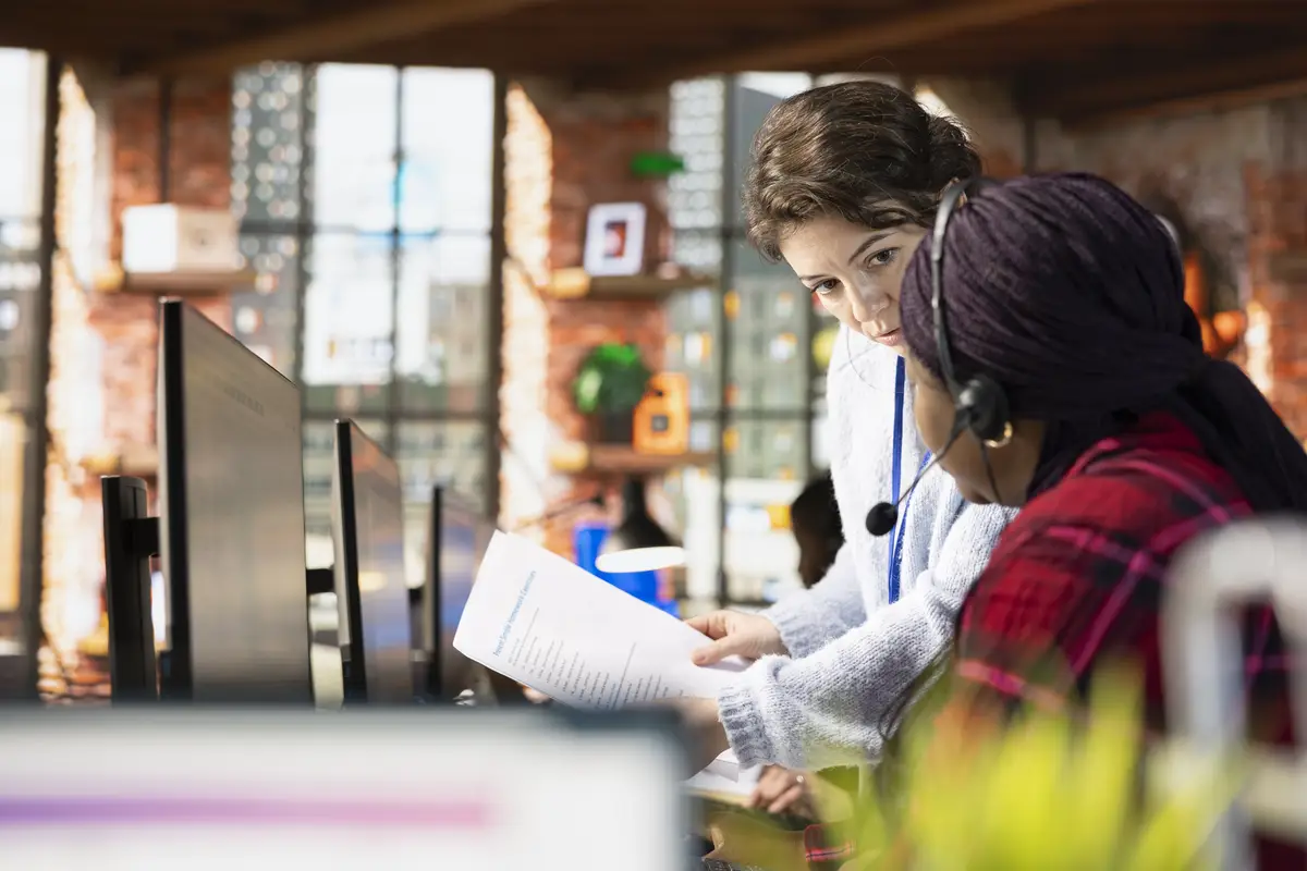 Call center onboarding specialist going over paperwork files with employee
