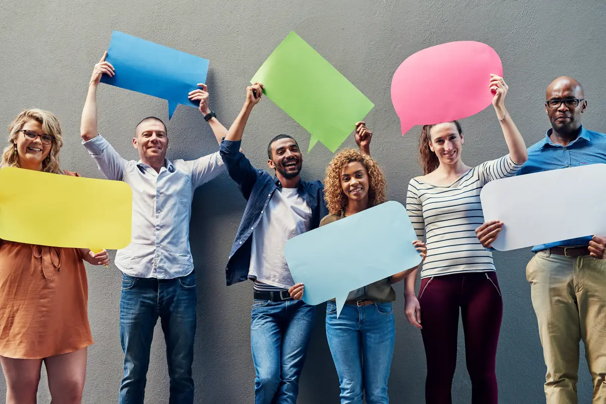 Business people portrait and speech bubbles with team for social media comment or feedback on a gray studio background Group of employees with smile or shape for review message or communication