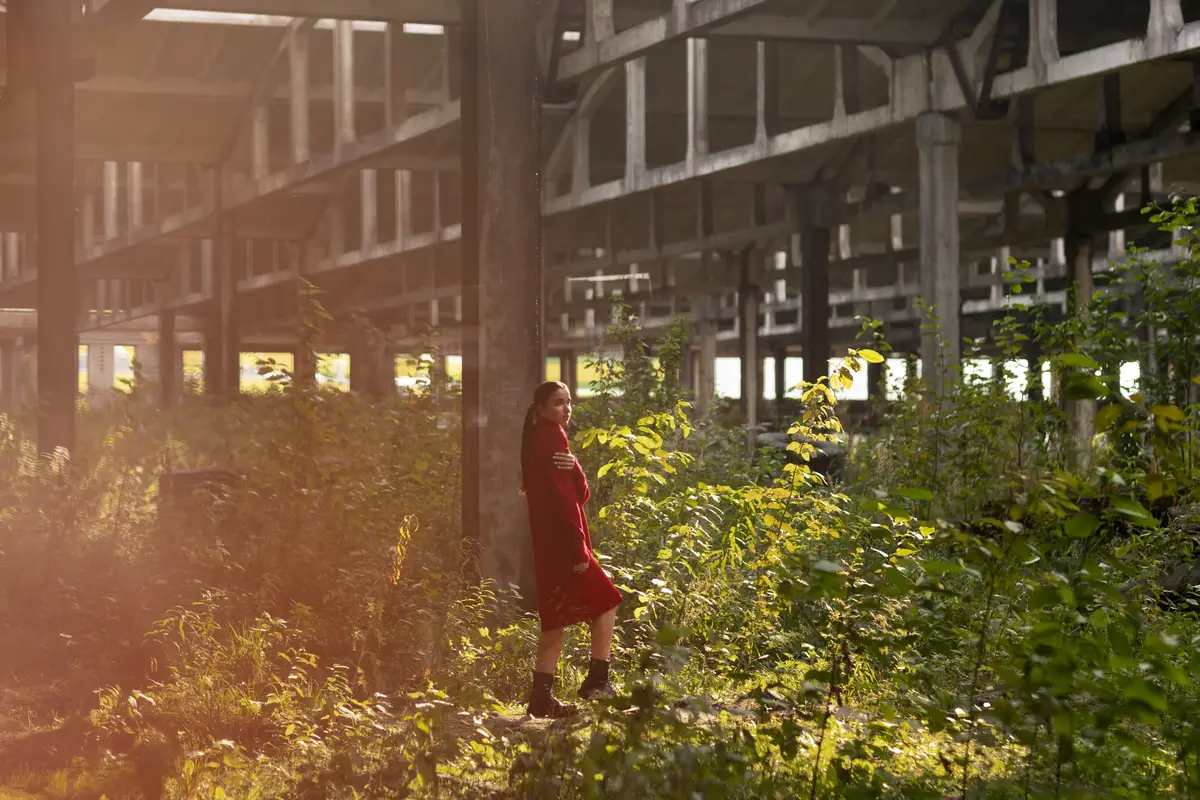 Female model being photographed with grunge environment during urban exploration