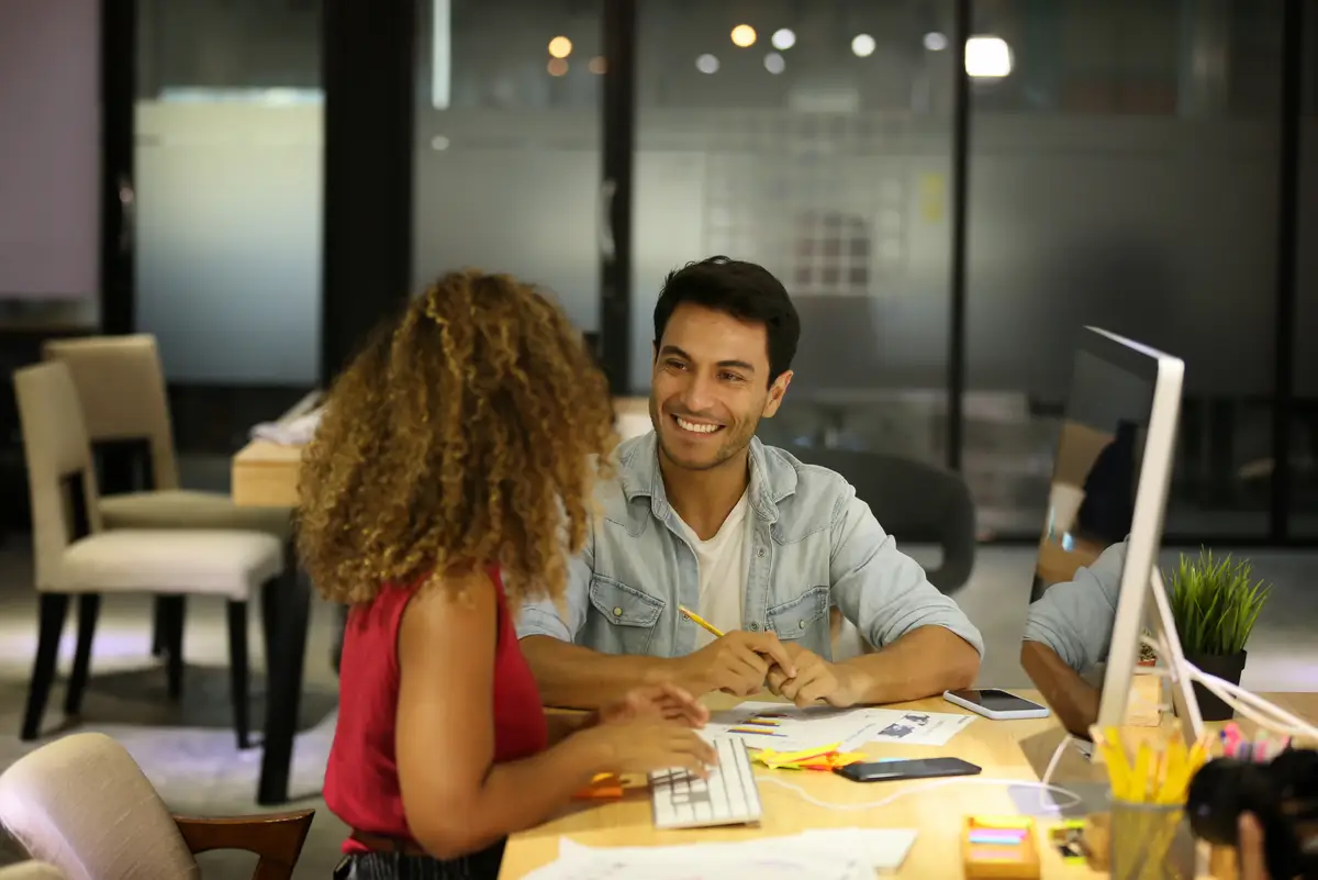 Young man using laptop while sitting on table