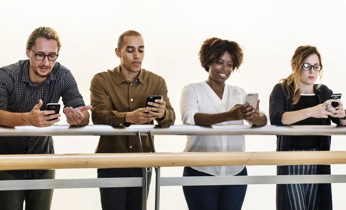 Group of diverse people using smartphones