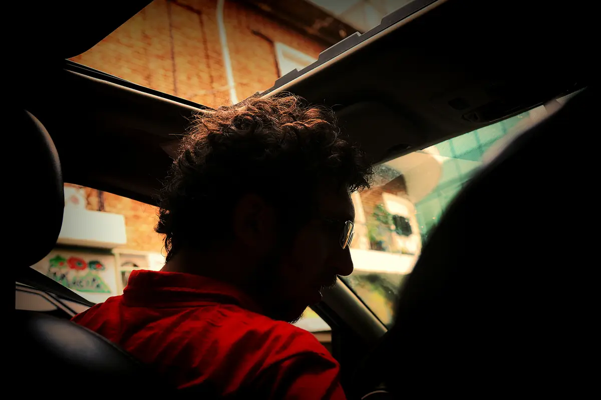Man wearing sunglasses while sitting in car