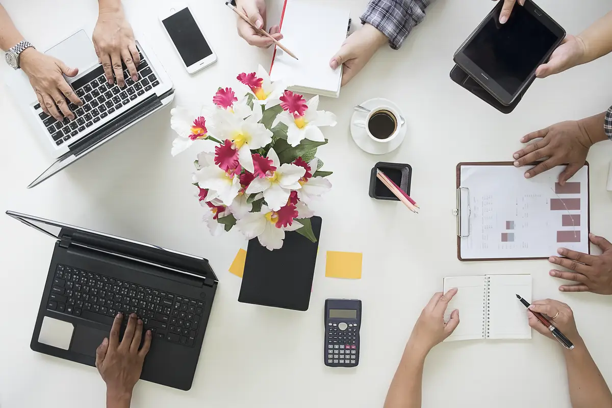Directly above view of people working on table