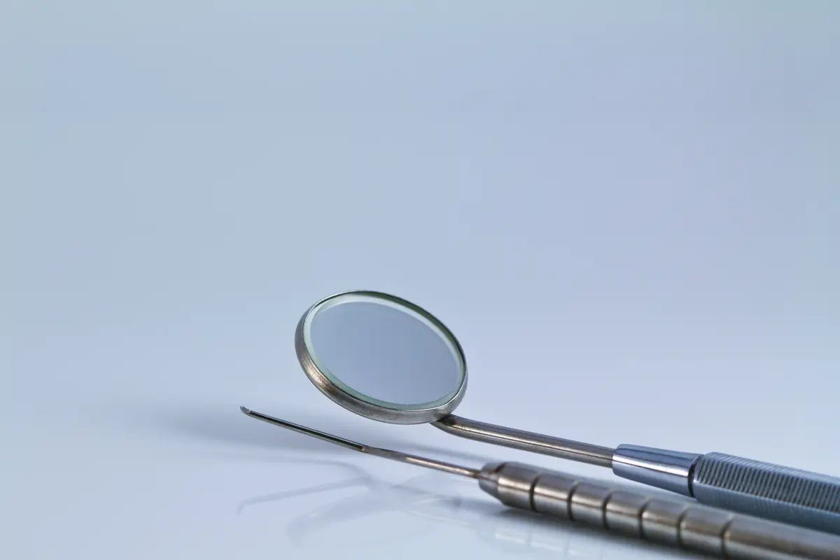 Dental tools and equipment on white background.
