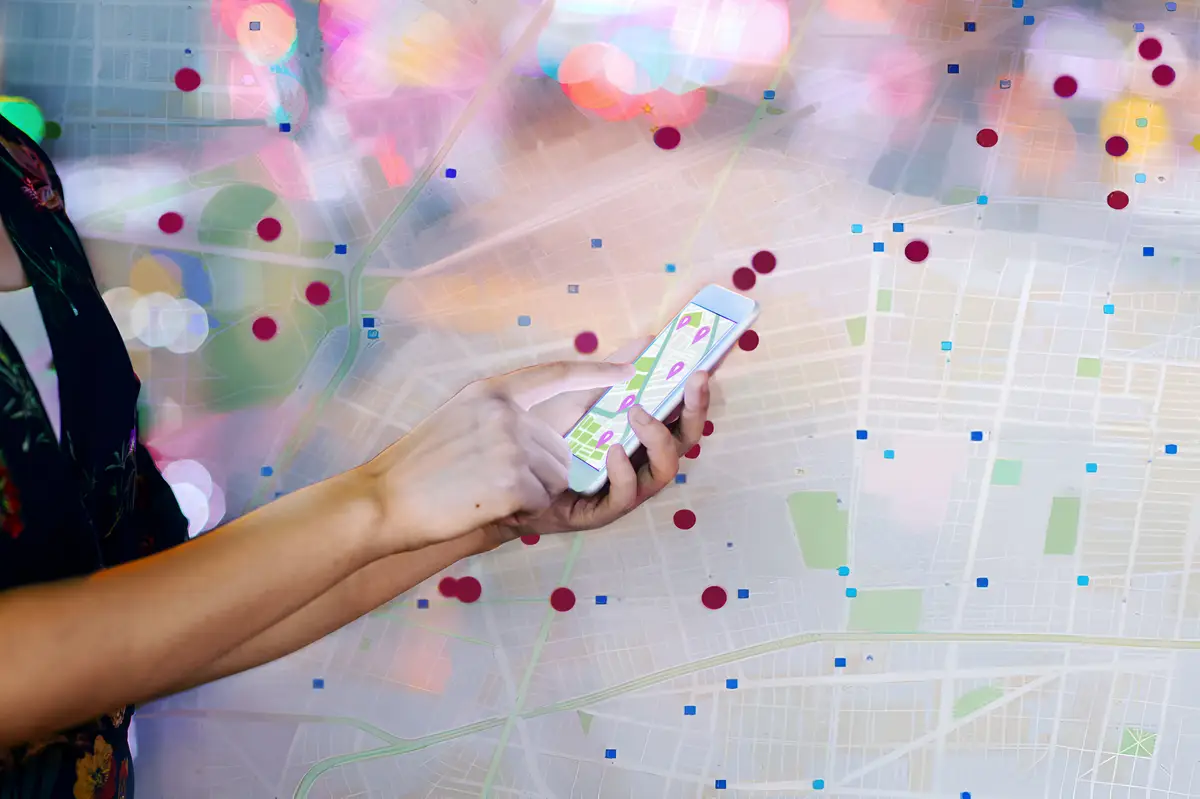 Multiple exposed image of map and hands holding mobile phone