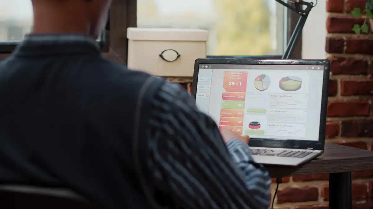 Sales assistant planning business charts on digital laptop, working with e commerce and e shopping management in company office. Manager using statistics to develop creative project.