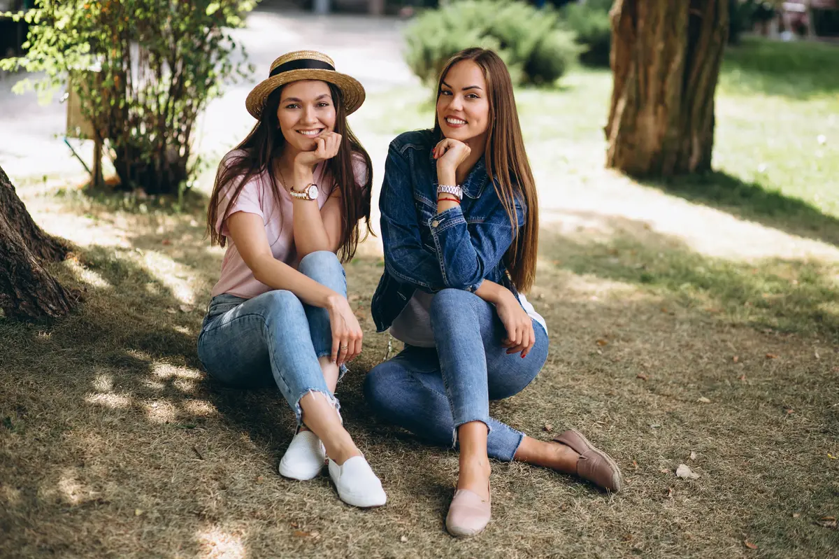 Two girls friends sitting in park