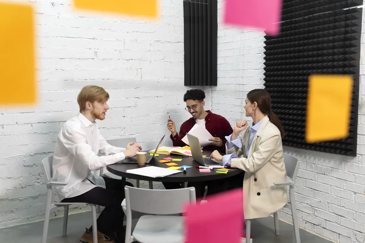 Full shot colleagues sitting at table