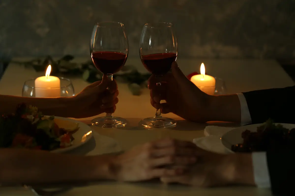 Couple holding their hands in restaurant