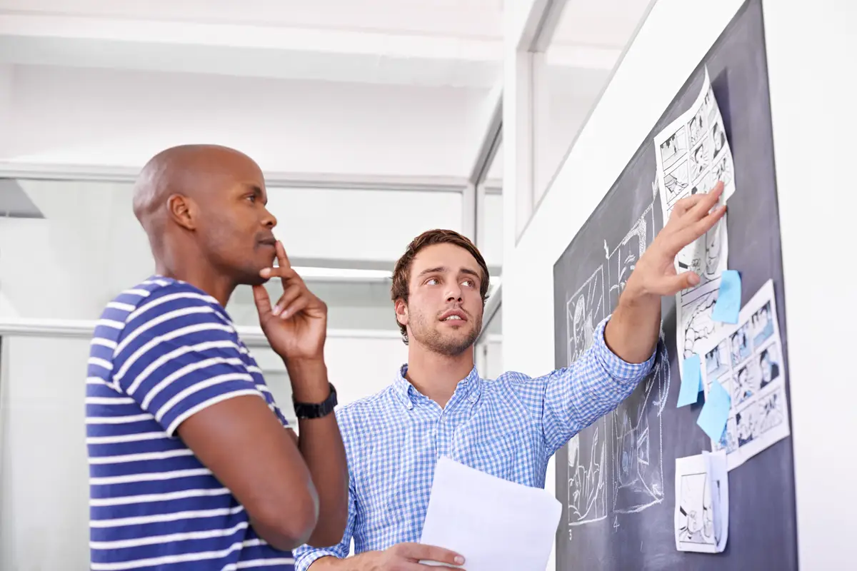 Business people thinking and creative by chalkboard in office for storyboard drawing and animation illustration Graphic design employees and teamwork by blackboard with idea for cartoon project