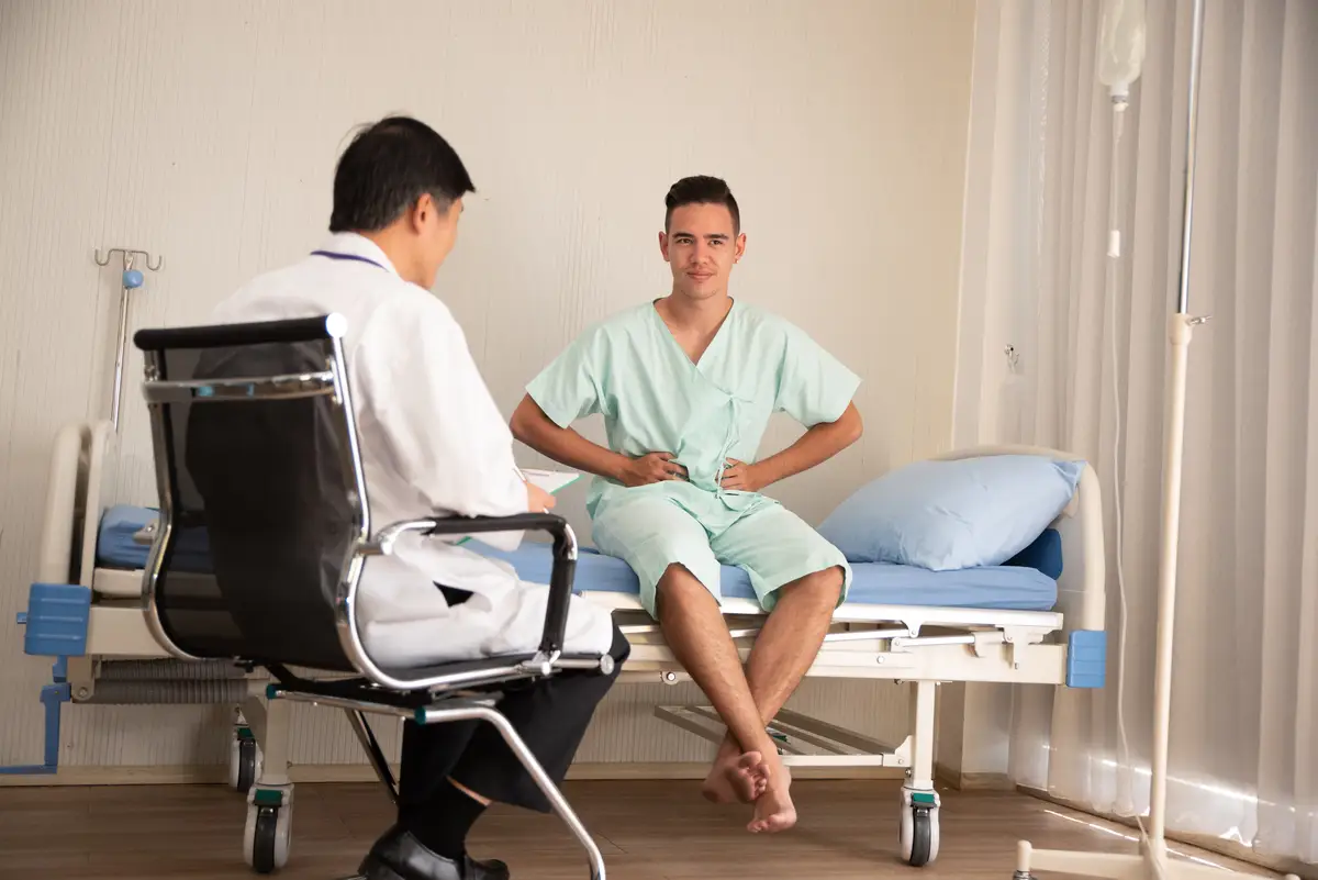 Doctor and patient discussing while sitting at hospital