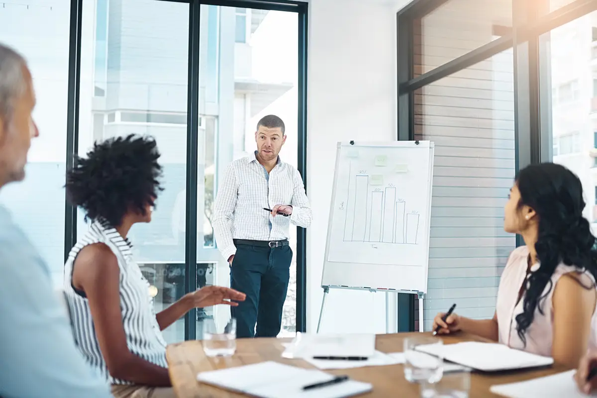 Running the numbers by the team Shot of a businessman giving a presentation on a whiteboard to colleagues in a boardroom