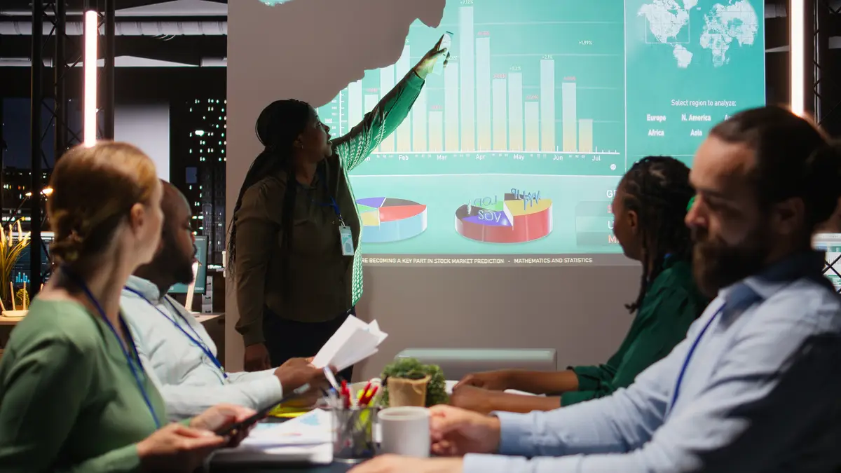 Diverse group of corporate associates look into project timelines and agenda create a strategy for