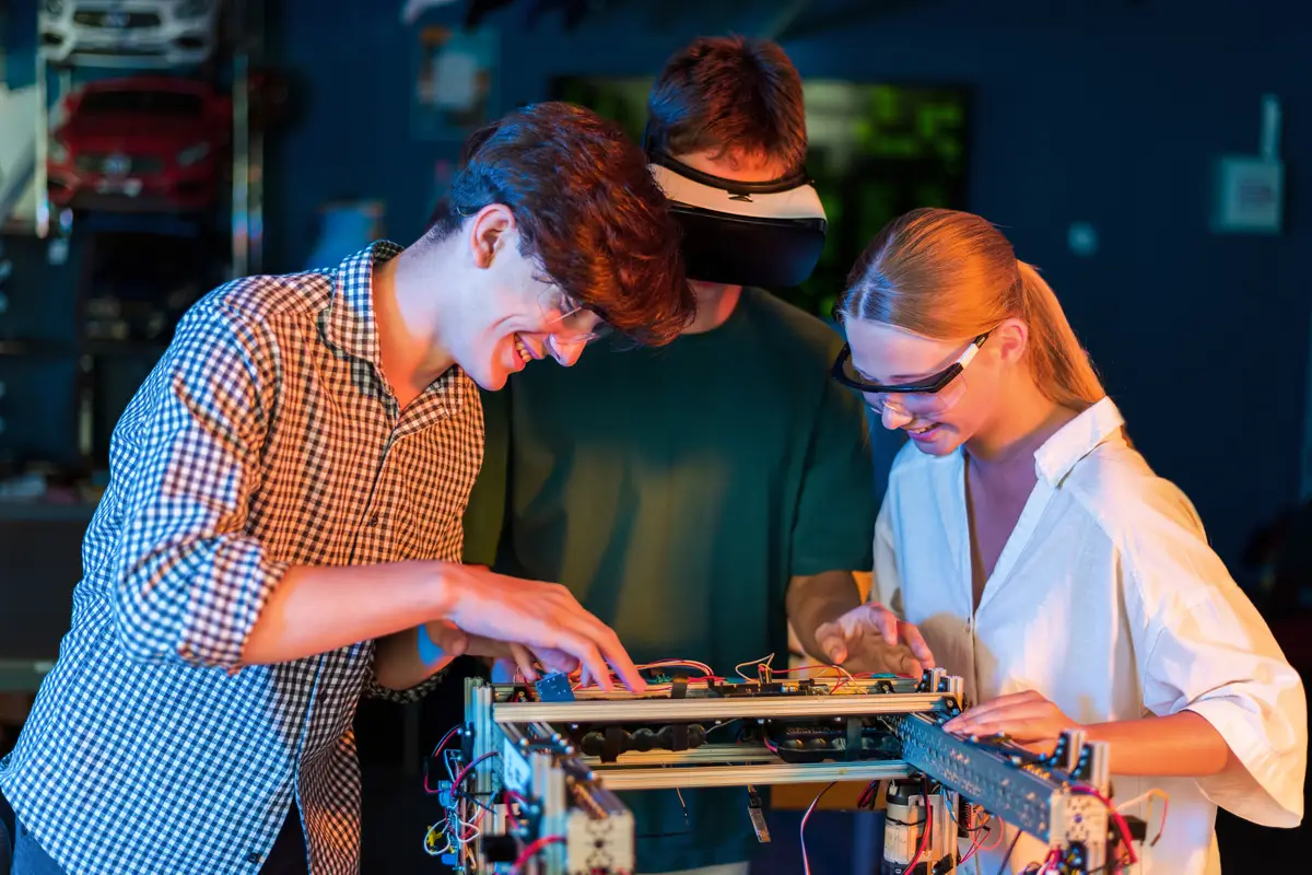Group of teens doing experiments in robotics in a laboratory Boys and girl in protective and VR