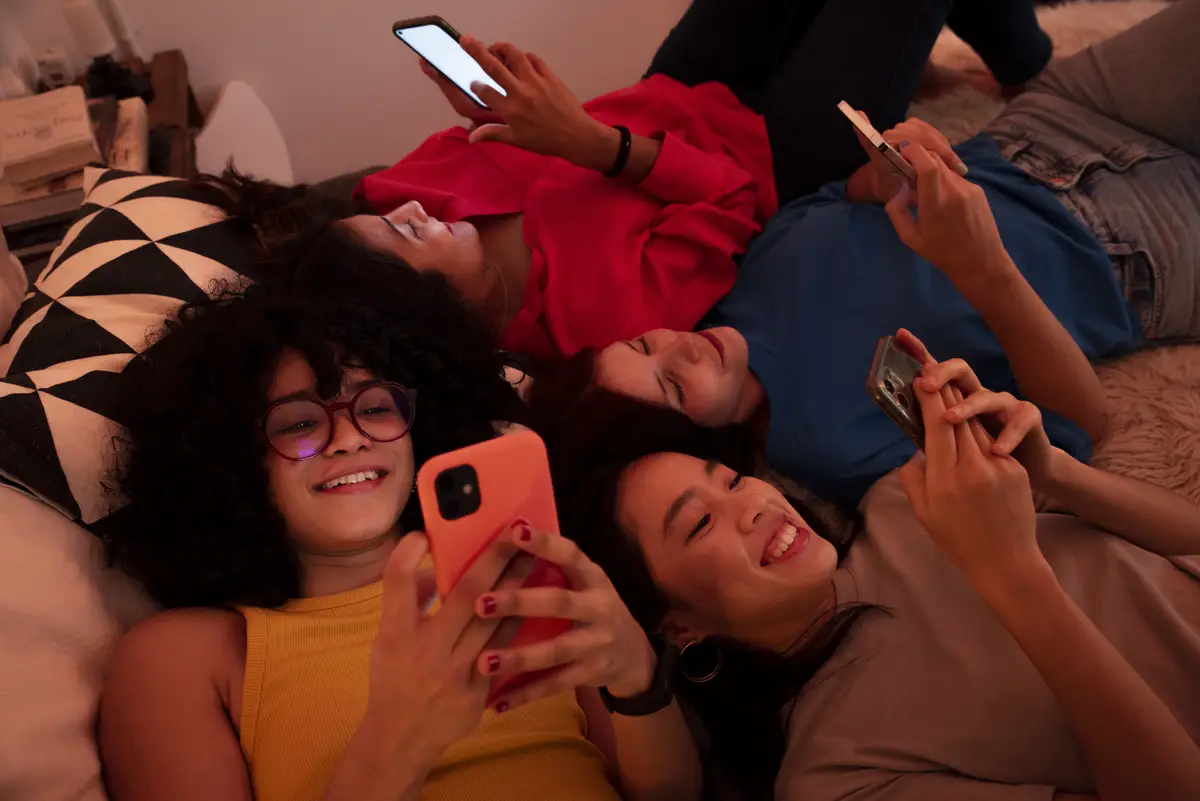 High angle smiley women with smartphones