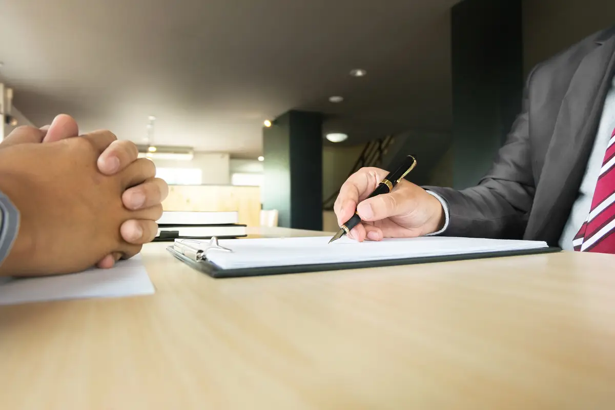 Midsection of colleagues working at office desk