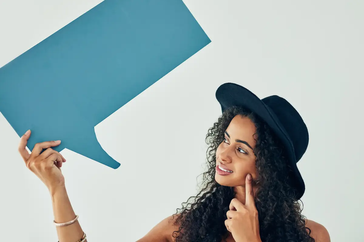 Young girl thinking and hat with speech bubble for social media trend or notification on a studio background Female person with question shape or quote in wonder fashion or style on mockup space