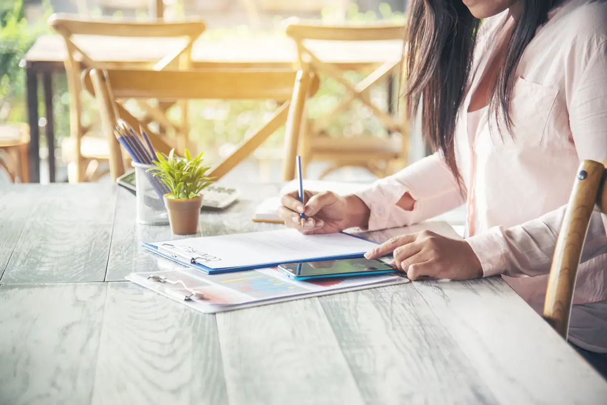 Woman working business office desk using laptop work from home Businesswoman looking financial business chart graph infographic analyze sale statistics Woman hands on entrepreneur office desk