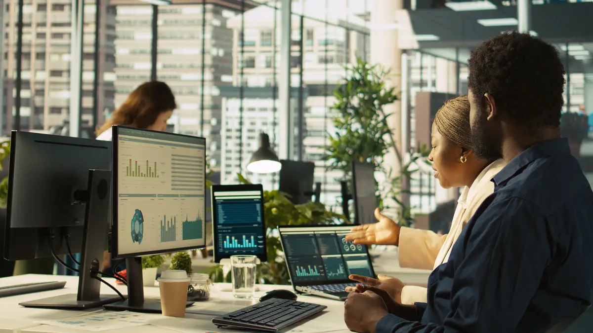 Angry manager in office berating worker for not hitting performance targets