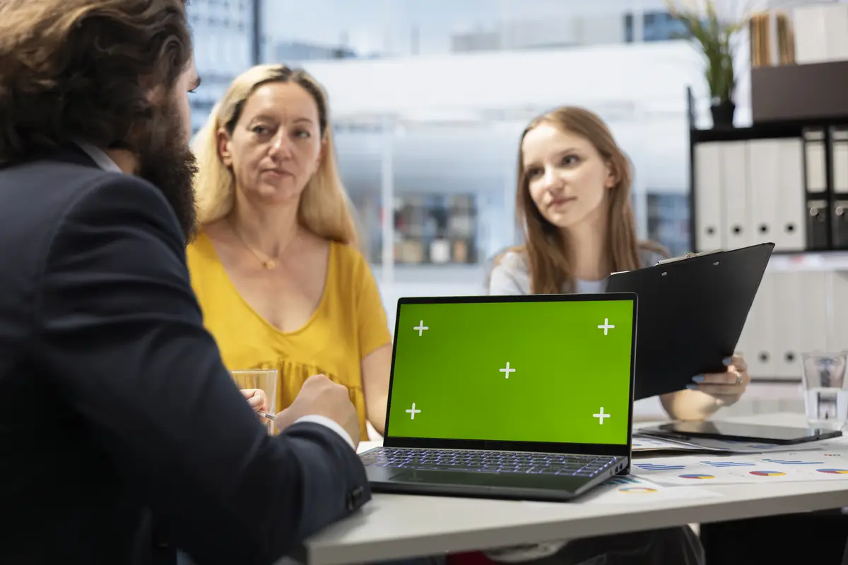Clients checking investment plan on chroma key laptop