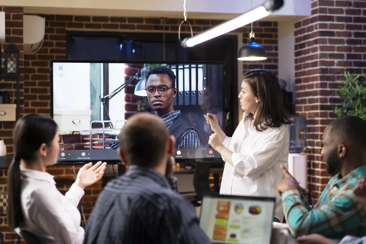 Team engaging in virtual meeting with businessman