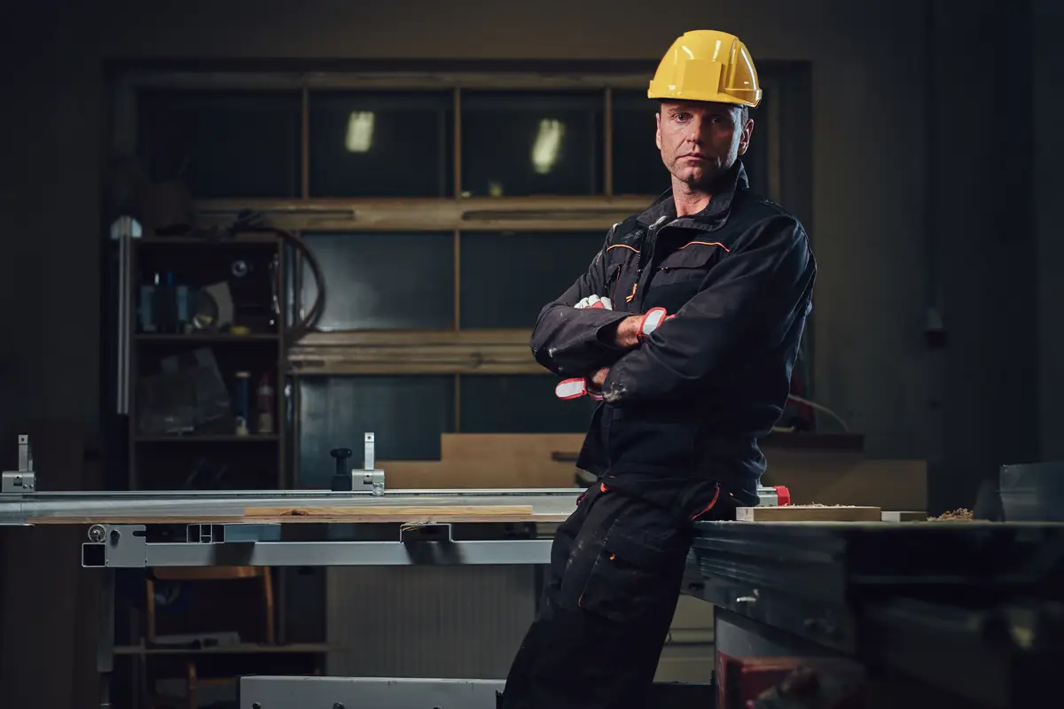 Portrait of carpenter male in a workshop.